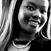 Portrait of Jacalla Bridges, a professional stylist at Theaology Salon & Day Spa, showcasing their expertise and style.