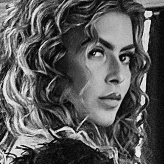 Portrait of Thea Ciallella, a professional stylist at Theaology Salon & Day Spa, showcasing their expertise and style.